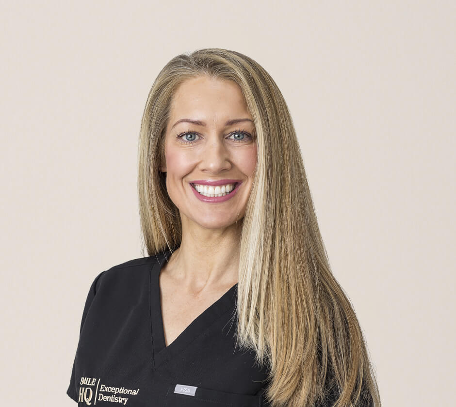 Portrait of a smiling female dentist wearing a black dental scrub at Smile HQ Exceptional Dentistry.