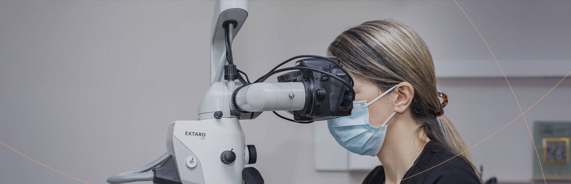 Image of a dental professional using a microscope to examine a patient, with a focus on precision in treatment.