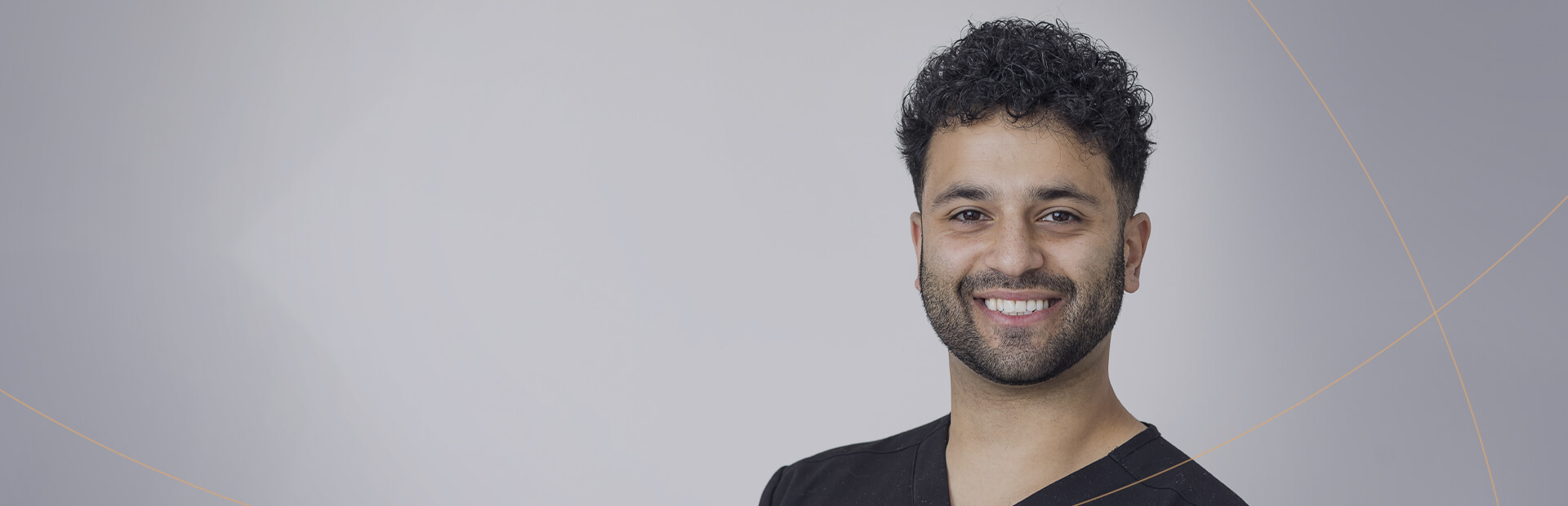 Portrait of a smiling cosmetic dentist, suitable for a promotional banner.