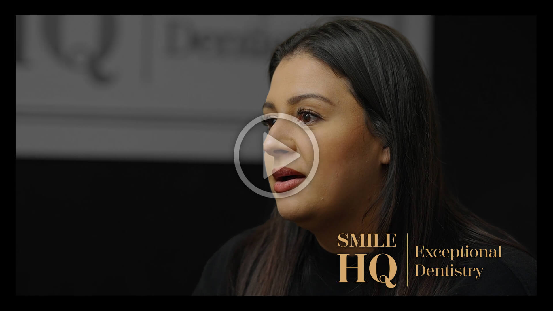 A woman with long black hair, speaking and sharing her experience during a patient story interview at Smile HQ.