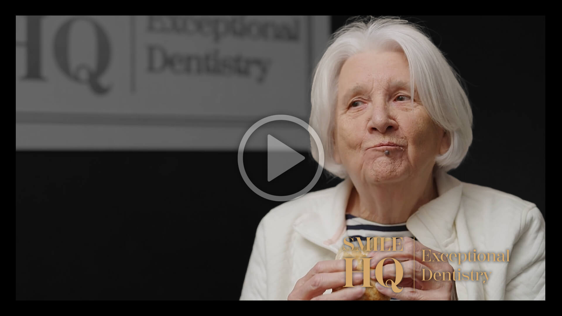 A senior woman smiling and sharing her experience in a patient story video.