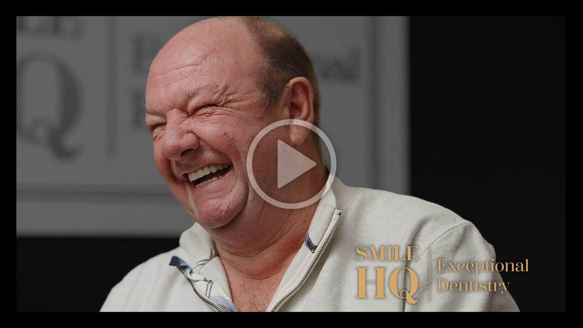 A happy patient laughing, sharing their dental experience, in a video interview.
