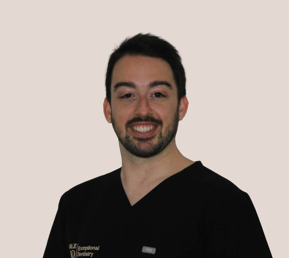 A portrait of a dentist in black scrubs at Smile HQ.