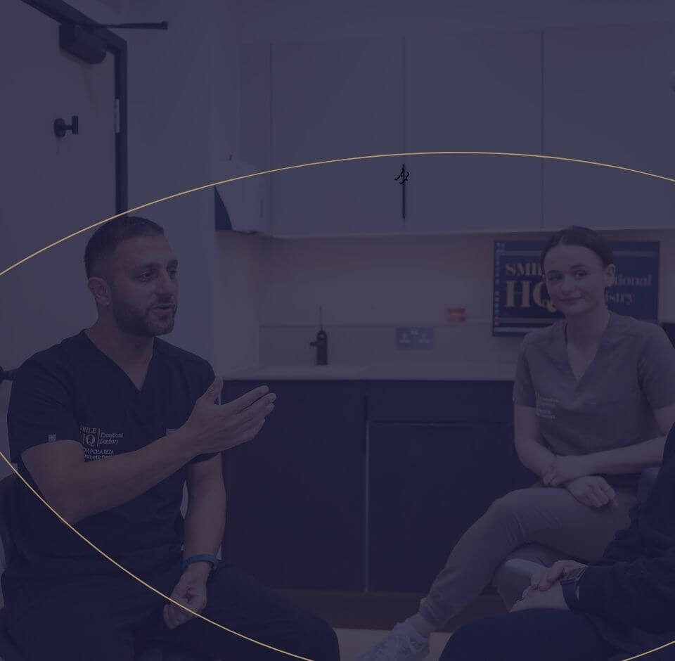 Image of a dentist speaking with a patient and dental professional in a consultation room at Smile HQ Exceptional Dentistry.