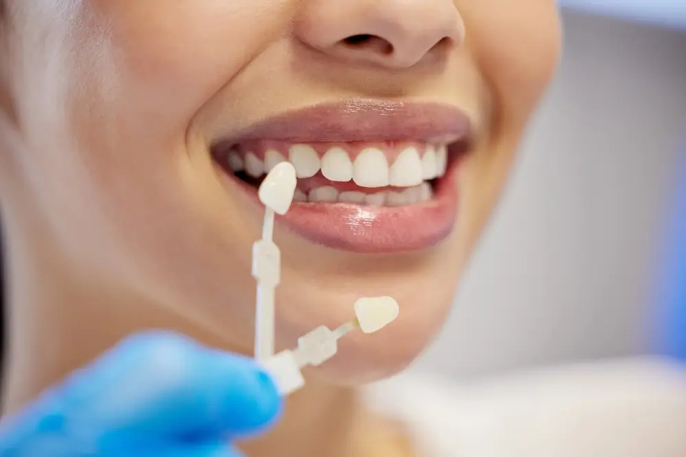 Woman smiling while getting teeth whitening treatment