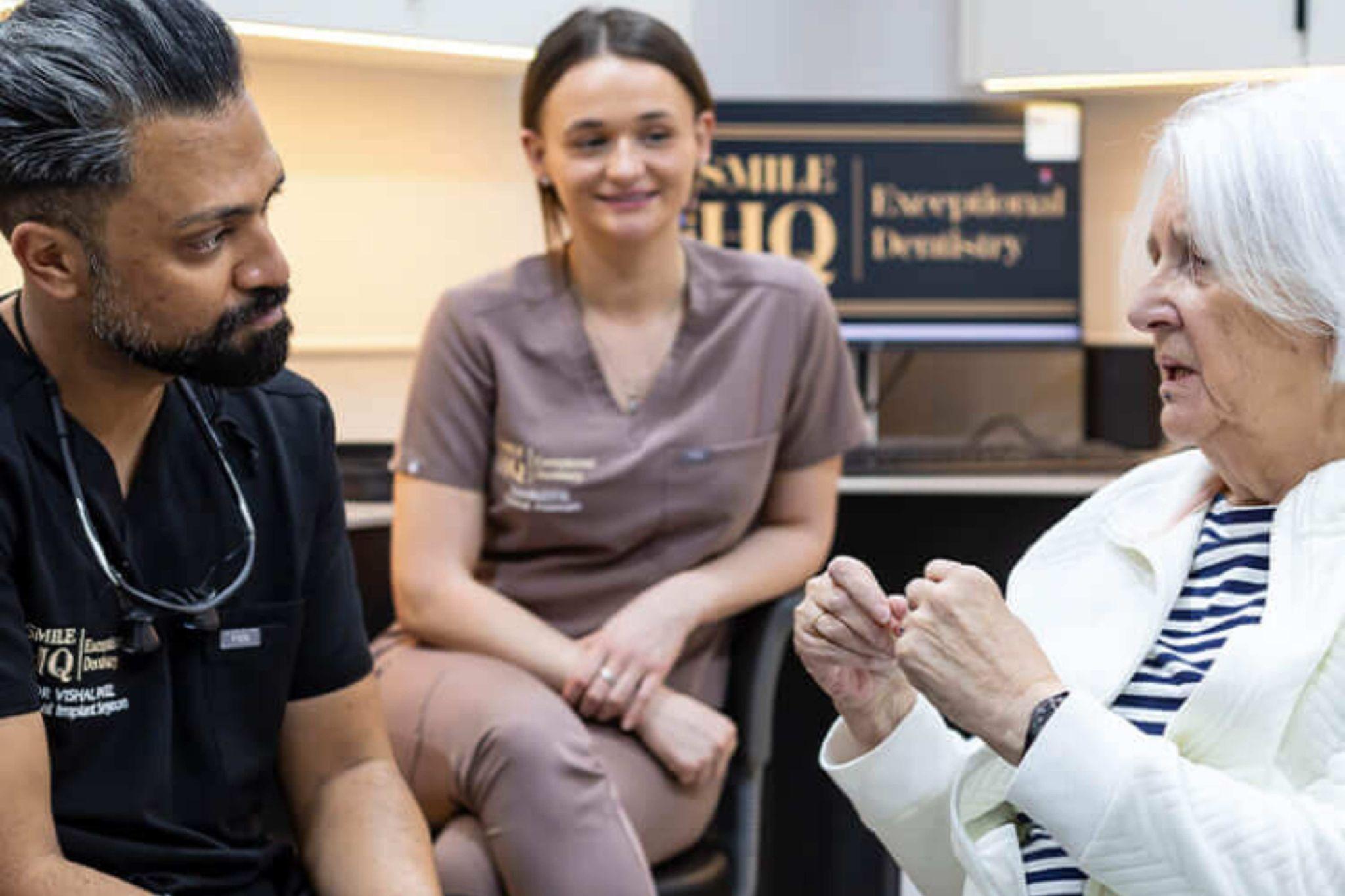 Dr Vishal Patel dental implant consultation with patient at SmileHQ Brentwood Essex discussing tooth replacement options