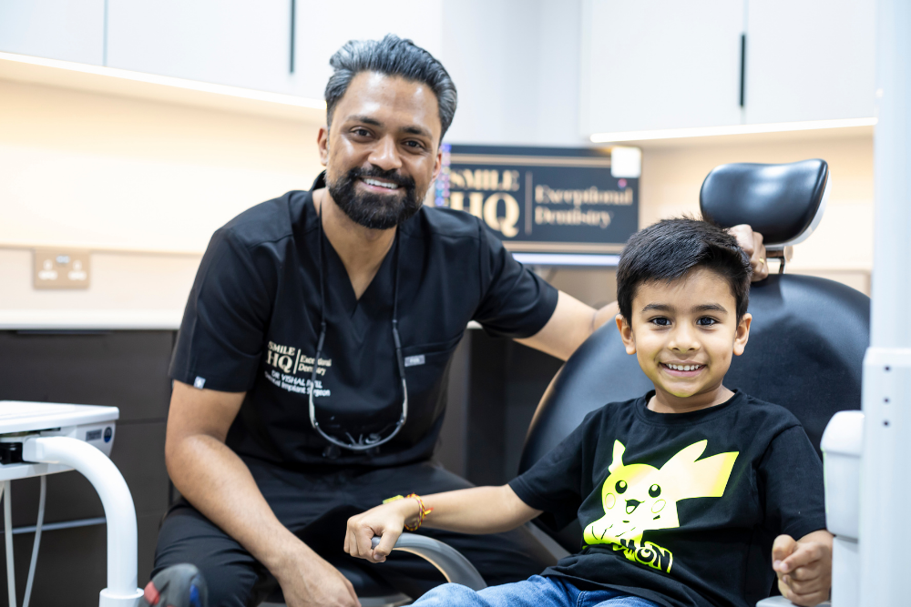 SmileHQ dentist Dr Vish with a young patient in the dental chair
