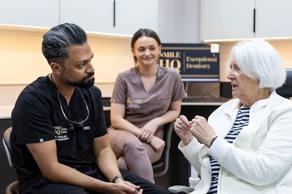 Nervous patient talking with the dental team at SmileHQ in Brentwood